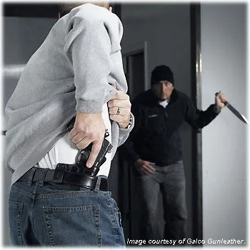 man drawing gun from holster against knife-wielding attacker