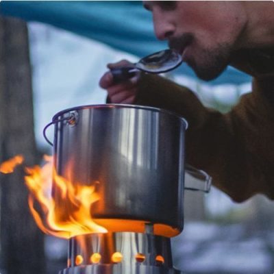 Man tasting food from the Solo Stove Pot 4000